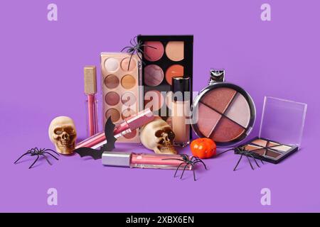 Set of different cosmetic products and Halloween decorations on color background Stock Photo