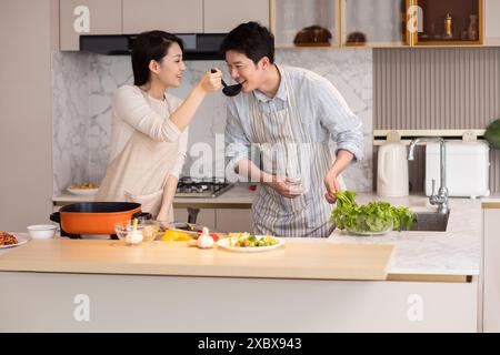 Couple Cooking In The Kitchen Stock Photo