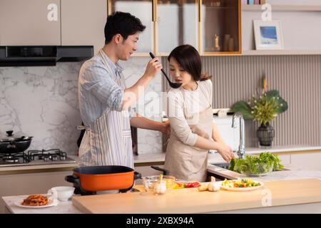 Couple Cooking In The Kitchen Stock Photo