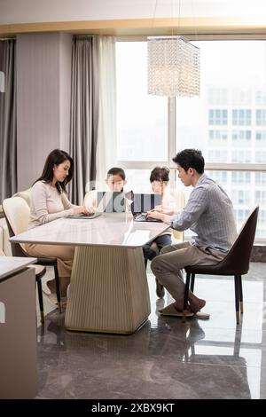 Family Using Laptops And Digital Tablets Stock Photo