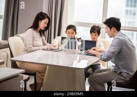 Family Using Laptops And Digital Tablets Stock Photo