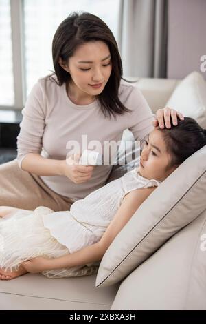 Mum Taking Daughter's Body Temperature Stock Photo - Alamy