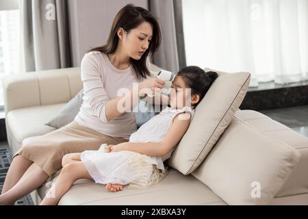 Mum Taking Daughter's Body Temperature Stock Photo - Alamy