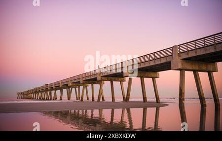 The magical colors of dusk reflecting in shallow pools of water on Jacksonville Beach in Northeast Florida. (USA) Stock Photo