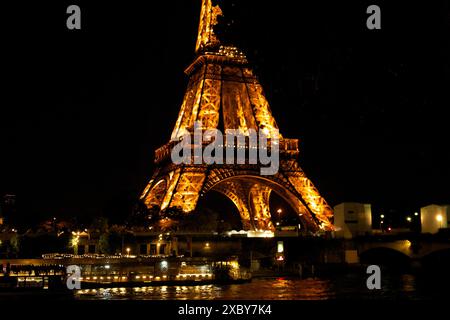 The illuminated Eiffel Tower in 2024 before the Olympic Games in the evening Stock Photo