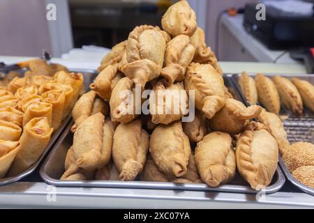 Display of Old Chang Kee delicious popular snack curry puff stack up in a pyramid shape. Spring roll is popular choice for customer. Singapore. Stock Photo