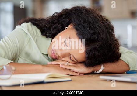 Black woman, tired and sleeping on desk with notebook for planning strategy, remote work and burnout in home. Entrepreneur, African lady and nap on Stock Photo