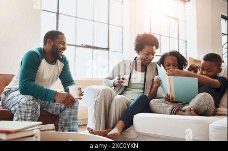 Reading, relax and black family with book on sofa for bonding together on fathers day at home. Smile, knowledge and African parents resting with Stock Photo