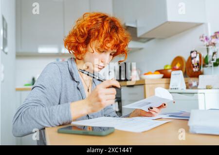 portrait attractive teenage girl filling out paper form Stock Photo