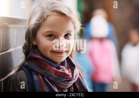 Hallway, smile and portrait of student in elementary school for academy, education and scholarship. Happy, face and girl at campus corridor for child Stock Photo