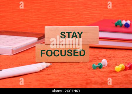 Concept words Stay focused written on a wooden block in a composition with business accessories Stock Photo