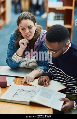 Library, people and studying with book, students and reading for exam, woman and man in campus of college. Project, friends and teamwork for test Stock Photo