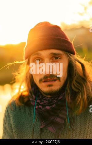 Portrait of a young long-haired man in a hat. Stock Photo