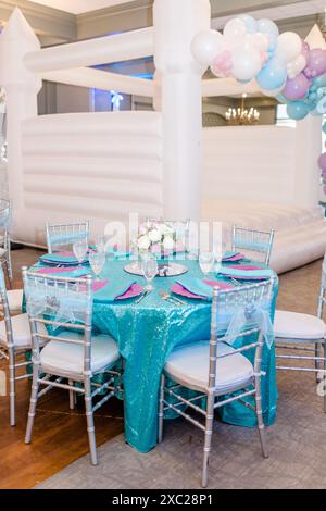 Indoor table setting with white bounce house Stock Photo