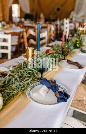 Fall wedding table setting with candles, vintage drink-wear and plates Stock Photo