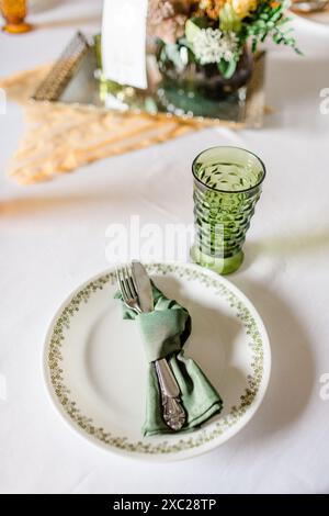 Green cut glass goblet with vintage place setting Stock Photo