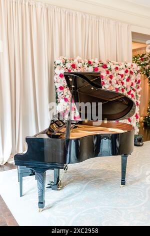 Grand Piano with floral wall and drapery Stock Photo