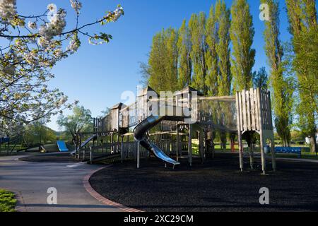 A playground without children can be a rather sad and eerie place. Here we see one in Abbey Fields, Abingdon, early on a spring day, just as the sun i Stock Photo