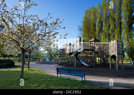 A playground without children can be a rather sad and eerie place. Here we see one in Abbey Fields, Abingdon, early on a spring day, just as the sun i Stock Photo