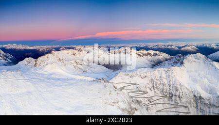 Aerial view of winding snowy mountain road at Stelvio Pass at sunrise Stock Photo