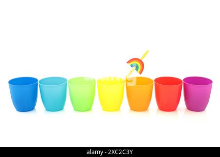 Rainbow drinking cups in a line on white background. Minimal colorful design composition with trans LGBT gay pride theme Stock Photo