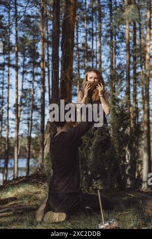 Company of friends spends time outdoors, in the forest. Stock Photo