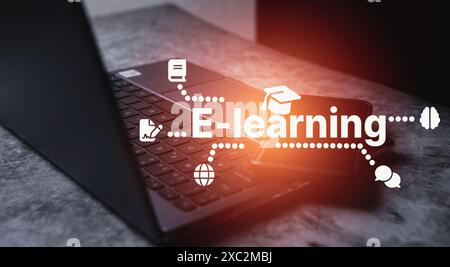 Laptop on desktop with E-learning futuristic interface. Use computer for online study. Internet education to creative thinking idea. Stock Photo