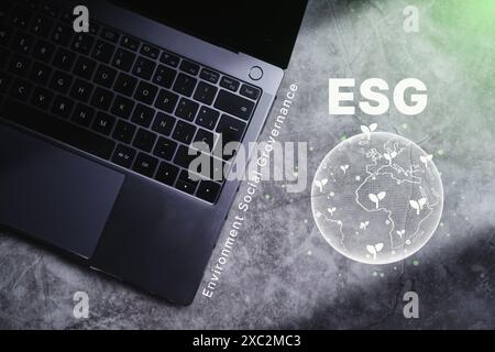 Laptop on desk with ESG icon green earth concept for Environment Society and Governance sustainable of the world. Green business natural environment. Stock Photo