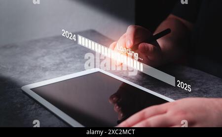 Woman use digital tablet with holographic interface for 2025 new year. New business start up. Target and goal action plan. Increasing business. Stock Photo