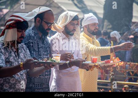 Kashmiri Pandit (Hindu) devotees pray during the annual Hindu festival Mata Kheer Bhawani Mela at the Kheer Bhawani Temple in the Tullamulla area of Ganderbal district, about 30 kilometres northeast of Srinagar. Amid tight security, thousands of Kashmiri Hindus, many of whom were displaced 25 years ago, attended the festival to pay homage to the Hindu goddess Mata Kheer Bhawani on her birth anniversary. Some 200,000 Kashmiri Pandits fled the Himalayan disputed region in the early 1990s at the start of an insurgency against Indian rule, mainly to the Hindu-dominated southern city of Jammu, and Stock Photo