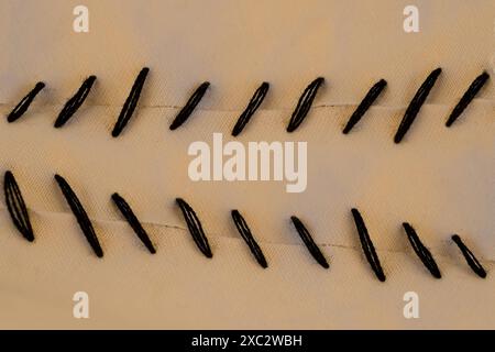 High-quality natural leather cut, ideal for crafting, Rugged black stitches traverse natural leather canvas, natural background for designer, Surgical Stock Photo