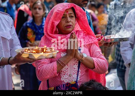 A Kashmiri Pandit (Hindu) devotee prays during the annual Hindu festival Mata Kheer Bhawani Mela at the Kheer Bhawani Temple in the Tullamulla area of Ganderbal district, about 30 kilometres northeast of Srinagar. Amid tight security, thousands of Kashmiri Hindus, many of whom were displaced 25 years ago, attended the festival to pay homage to the Hindu goddess Mata Kheer Bhawani on her birth anniversary. Some 200,000 Kashmiri Pandits fled the Himalayan disputed region in the early 1990s at the start of an insurgency against Indian rule, mainly to the Hindu-dominated southern city of Jammu, an Stock Photo