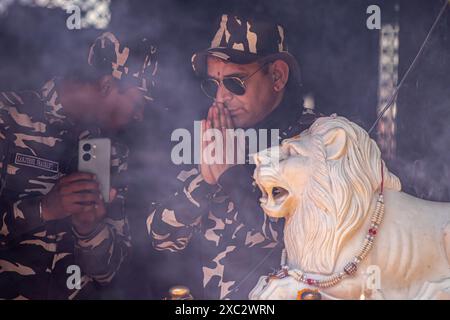 India paramilitary troopers pray during the annual Hindu festival Mata Kheer Bhawani Mela at the Kheer Bhawani Temple in the Tullamulla area of Ganderbal district, about 30 kilometres northeast of Srinagar. Amid tight security, thousands of Kashmiri Hindus, many of whom were displaced 25 years ago, attended the festival to pay homage to the Hindu goddess Mata Kheer Bhawani on her birth anniversary. Some 200,000 Kashmiri Pandits fled the Himalayan disputed region in the early 1990s at the start of an insurgency against Indian rule, mainly to the Hindu-dominated southern city of Jammu, and they Stock Photo