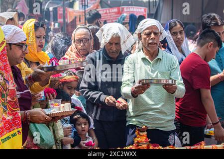 Kashmiri Pandit (Hindu) devotees pray during the annual Hindu festival Mata Kheer Bhawani Mela at the Kheer Bhawani Temple in the Tullamulla area of Ganderbal district, about 30 kilometres northeast of Srinagar. Amid tight security, thousands of Kashmiri Hindus, many of whom were displaced 25 years ago, attended the festival to pay homage to the Hindu goddess Mata Kheer Bhawani on her birth anniversary. Some 200,000 Kashmiri Pandits fled the Himalayan disputed region in the early 1990s at the start of an insurgency against Indian rule, mainly to the Hindu-dominated southern city of Jammu, and Stock Photo