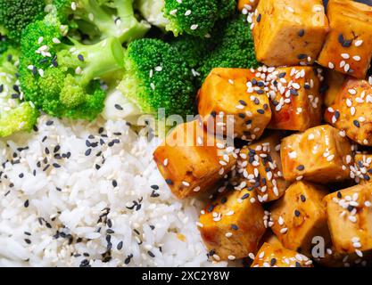 rice and fried tofu with sesame seeds as background, top view Stock Photo