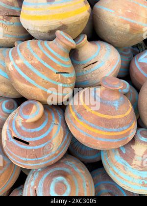 Clay Piggy Banks Pots with Colorful Stripes for Saving Coins and Cash. Stock Photo