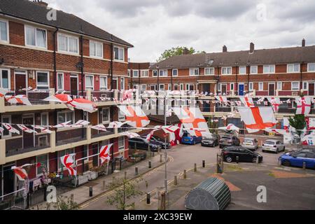 London, UK. 14 June.2024.  Residents  of the Kirby Estate in Bermondsey south-east London have put up hundreds of England ( St George's Cross ) flags and bunting ahead of The UEFA EURO 2024 soccer tournament which begins on 14 June 2024 when host nation Germany play Scotland in Munich. England will play their fist game of the tournament against Serbia on 16 June. Credit: Amer Ghazzal/Alamy Live News Stock Photo