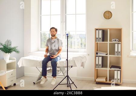 Male patient is having an intravenous vitamin treatment in a modern medical office Stock Photo