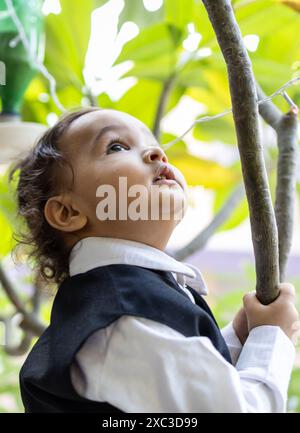 cute indian toddler baby boy in black suit at outdoor from different angle Stock Photo