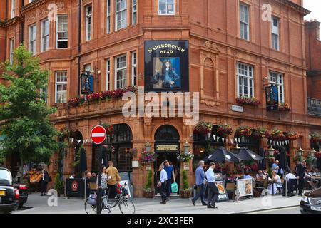 LONDON, UK - JULY 7, 2016: People visit Marlborough Head pub in Mayfair district of London UK. There are more than 7,000 pubs in London. Stock Photo