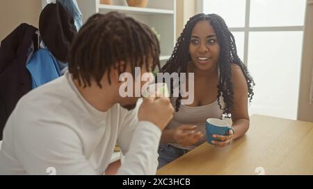 A couple enjoys a conversation over coffee in a cozy, well-lit living room, exuding warmth and love. Stock Photo