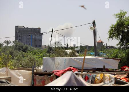 Palestinian youth lose some equipment and empty ammunition left by the Israeli army in along a street in the western part of Rafah Smoke plumes billow in Rafah in the southern Gaza Strip on June 14, 2024 amid the ongoing Israel war on Gaza. Photo by Omar Ashtawy apaimages Rafah Gaza Strip Palestinian Territory 140624 Rafah OSH 0011 Copyright: xapaimagesxOmarxAshtawyxxapaimagesx Stock Photo