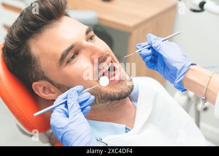 Handsome young man in stomatology clinic. Dental care Stock Photo