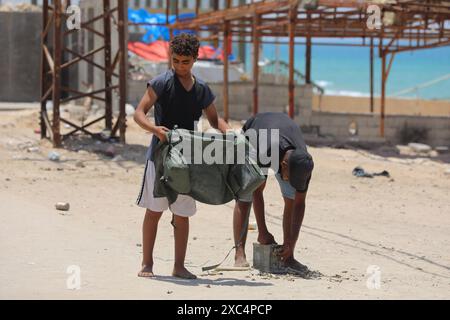 Palestinian youth lose some equipment and empty ammunition left by the Israeli army in along a street in the western part of Rafah Palestinian youth lose some equipment and empty ammunition left by the Israeli army in along a street in the western part of Rafah in the southern Gaza Strip on June 14, 2024 Photo by Omar Ashtawy apaimages Rafah Gaza Strip Palestinian Territory 140624 Rafah OSH 0022 Copyright: xapaimagesxOmarxAshtawyxxapaimagesx Stock Photo