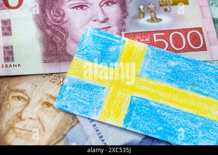 Sweden finance, hand painted Sweden flag with crayons and Swedish krona banknotes, concept, financial education and learning money management Stock Photo