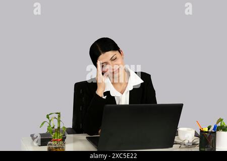 Beautiful Asian Indian Receptinist Entrepreneur with laptop, headphone and diary gives gestures  and expressions Stock Photo