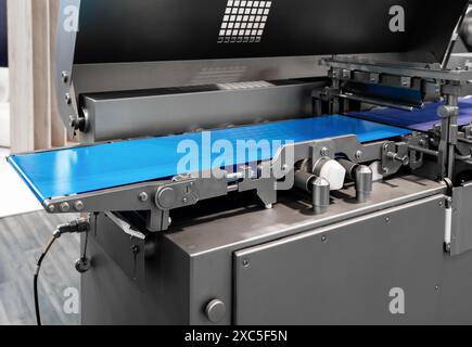 Automated sealing machine and packaging line. Stock Photo