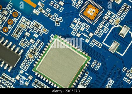 Microchip on Blue Circuit Board Stock Photo