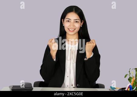 Beautiful Asian Indian Receptinist Entrepreneur with laptop, headphone and diary gives gestures  and expressions Stock Photo