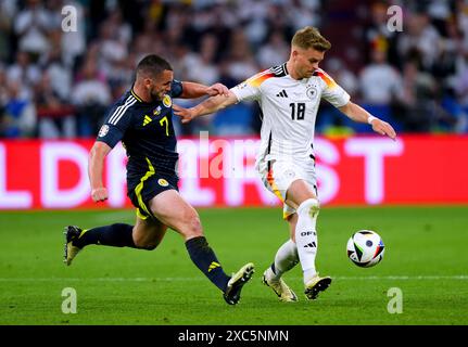 Scotland's John McGinn (left) and Germany's Maximilian Mittelstadt battle for the ball during the UEFA Euro 2024 Group A match at the Munich Football Arena in Munich, Germany. Picture date: Friday June 14, 2024. Stock Photo